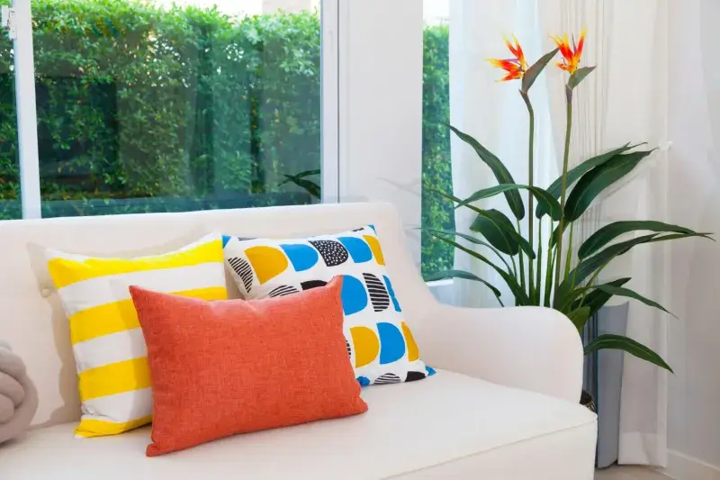 tropical throw pillows with mixed color combinations on sofa